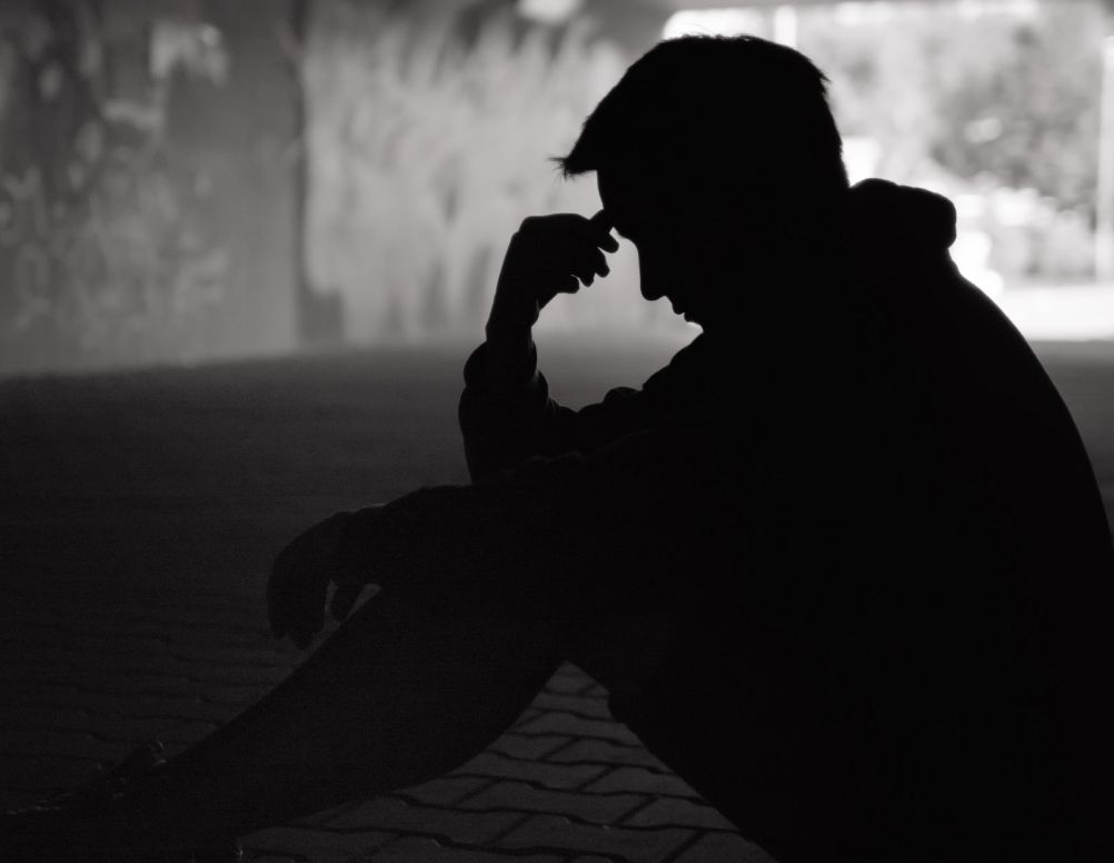 Silhouette of man needing support for mental illness 